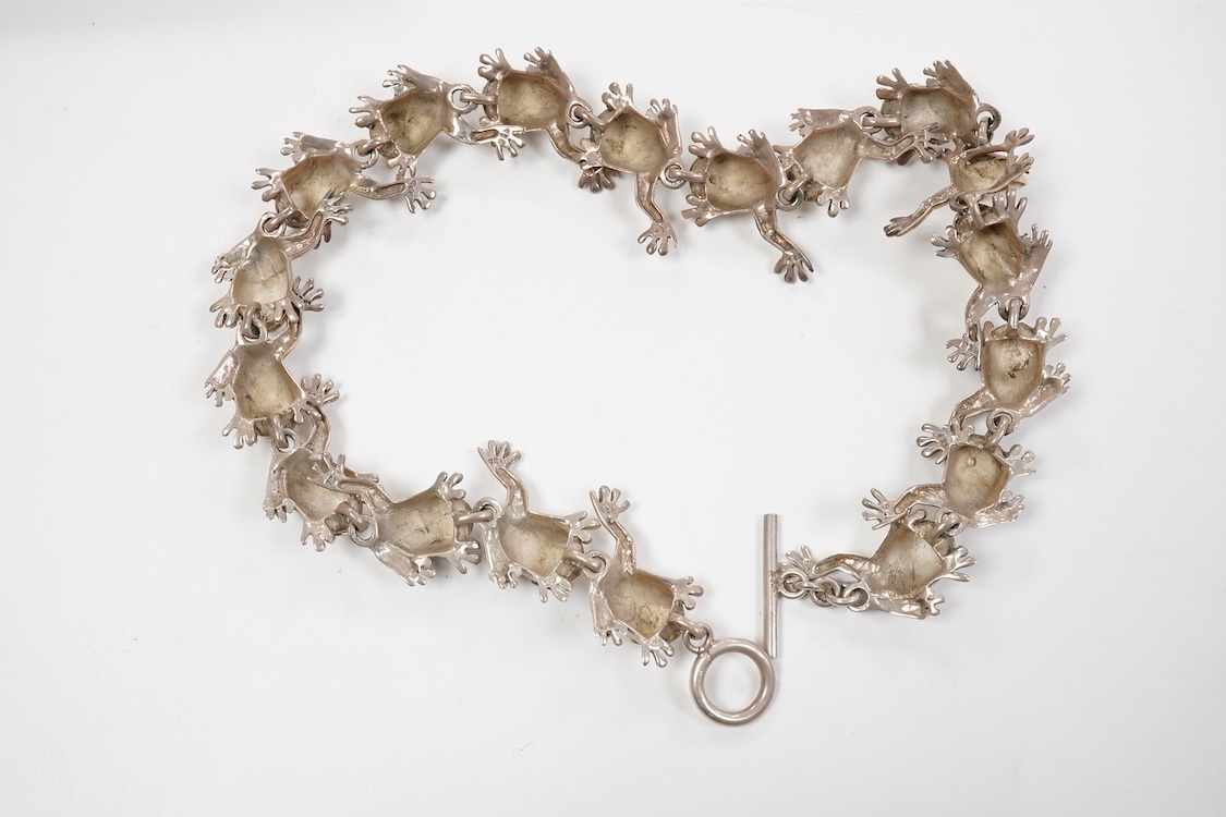 A recent white metal frog necklace, overall length 42cm and matching bracelet, 19cm, both stamped 925, gross 153 grams.
